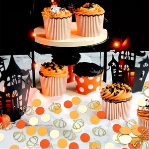 Thanksgiving pumpkin confetti and autumn party decorations with festive harvest cupcake setup