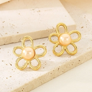 Macro view of French vintage floral 18K gold stainless steel earrings with pearl centers