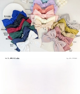 Macro detail of high-quality satin bow hair clips in various vibrant colors