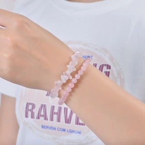 Detail of pink crystal natural stone double-layer bracelet worn on a female wrist