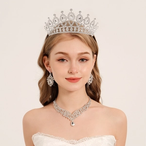 Elegant bridal jewelry set with silver tiara, necklace and earrings featuring clear rhinestones