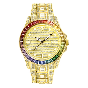 Close-up of golden quartz watch featuring rainbow crystal bezel and iced-out diamond dial