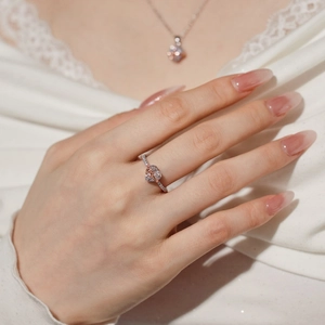 Close-up of S925 silver heart ring with rose gold trim and cubic zirconia on a model