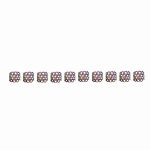 Detailed view of ten rainbow hollow filigree metal dreadlock cuffs on a white background