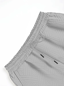 Détail du tissu jacquard gris texturé avec taille élastique et cordon de serrage réglable