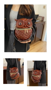 Detail of owl-shaped crossbody bag with feather texture, gold zippers and black strap