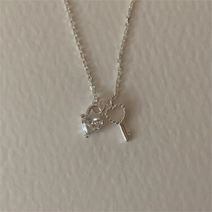 Silver heart lock and key pendant necklace with clear zircon stones on a fine chain