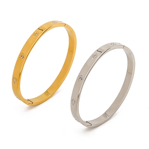 Close-up of gold and silver eight-pointed star bracelets with cubic zirconia inlays