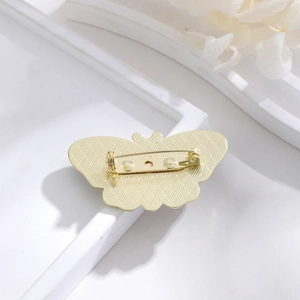 Golden butterfly brooch with back safety pin clasp and textured metal finish design