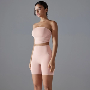 Close-up of pink seamless sports bra and high-waist biker shorts with side ruching