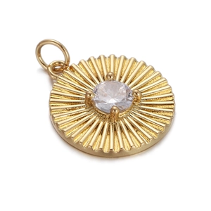 Detailed view of a gold-plated doughnut charm with a sparkling central zircon stone