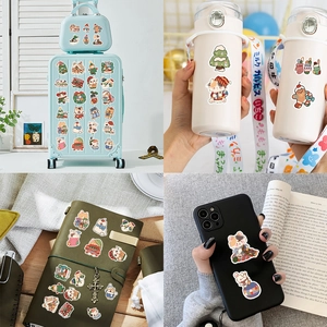 Christmas stickers set showing application on luggage, water bottle, and laptop surface