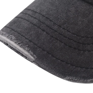 Detailed macro view of vintage washed grey cotton baseball cap brim with distressed edges