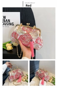 Detail of red peony embroidery on vintage shell bag with tassels and gold chain