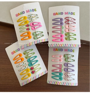 Detailed view of colorful fruit patterns and plaid BB hair clips on display cards