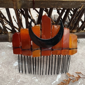 Detail of red carnelian stones and black crescent moon on a handmade bridal hair comb