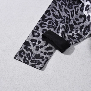 Detailed close-up of silver leopard print cuffs with high-quality stitching on fabric