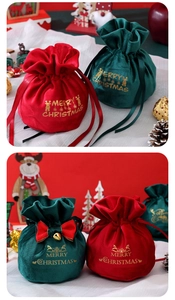 Close-up of velvet Christmas drawstring gift bags with gold foil prints and bow bells