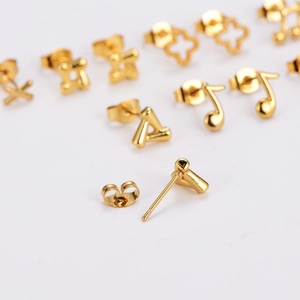 Minimalist gold stainless steel stud earrings set featuring musical notes and floral shapes