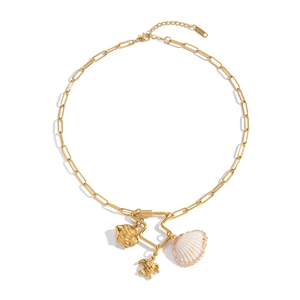 Detailed shot of 18K gold plated paperclip chain with shell, fish, and turtle charms