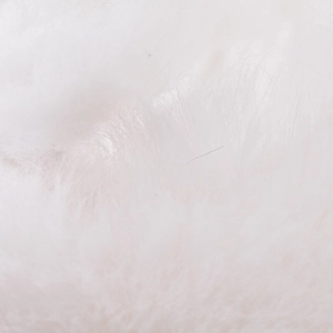 Detailed macro view of the soft white rabbit fur texture on this winter baseball cap
