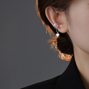 Silver multi-layer ear cuff with heart pendant shown on model in a detailed side view