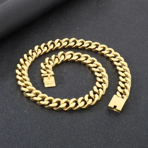 Detailed close-up of golden stainless steel Cuban link chain with secure box clasp