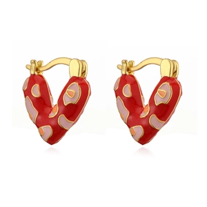 Macro detail of V-shaped gold ear cuffs with vibrant red enamel and polka dots