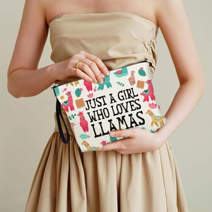 Llama and cactus printed canvas makeup bag with a black wrist strap and zipper closure