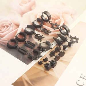 Detail view of black punk earring set featuring skull, star, and stud designs