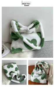 Detail view of plush faux fur tote bag with green heart pattern and soft shoulder strap