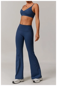 Detail of dark blue V-neck sports bra and flared yoga pants set in high elastic matte fabric