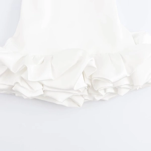 White sleeveless backless bubble dress with elegant ruffled hemline and satin finish
