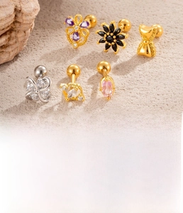 Detailed view of 6-piece titanium steel cartilage studs with zircon floral and bow designs