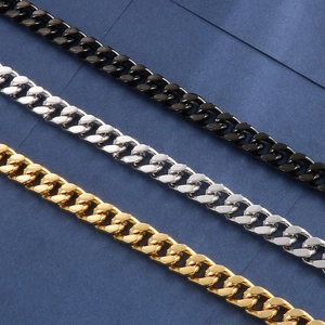 Detailed view of three stainless steel Cuban link necklaces in gold, silver, and black finish
