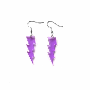 Macro view of purple glitter acrylic lightning earrings with silver metal hooks