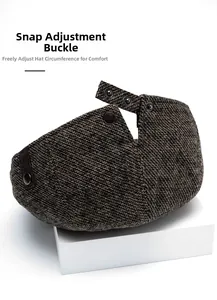 Detail of adjustable metal snap buckles on brown herringbone newsboy cap back