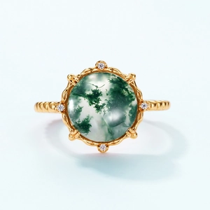Macro view of gold moss agate ring with textured band and small white diamonds