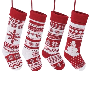 Set of four red and white knitted Christmas stockings with reindeer and snowflake patterns