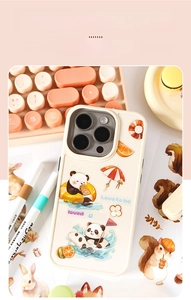 Close-up of cute panda and orange DIY stickers on a cream-colored phone case