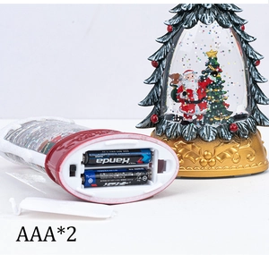 Detailed view of Christmas tree lantern with Santa inside and battery compartment