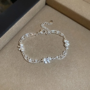 Detail of silver bow bracelet with zircons and lobster clasp on jewelry display box