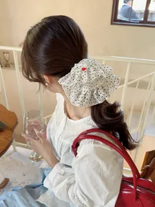 Polka dot oversized chiffon scrunchie worn by a model in an elegant lifestyle setting