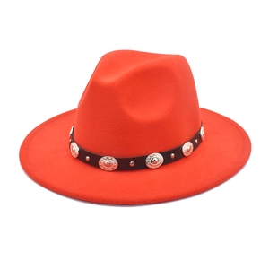 Detail view of red wool jazz hat with a black leather band and silver embossed rivets