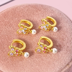 Détails de boucles d'oreilles papillon dorées avec zircons colorés et perles blanches