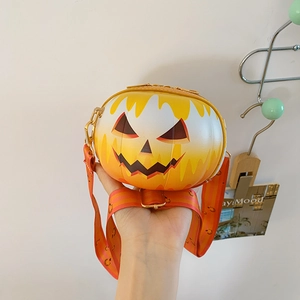 Macro shot of Halloween pumpkin smile handbag with striped wide shoulder strap