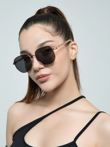 Close-up of gold metal sunglasses frame with textured temples and black lenses