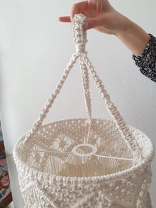 Detail of handmade cream cotton macrame lampshade with tassel fringe and woven textures