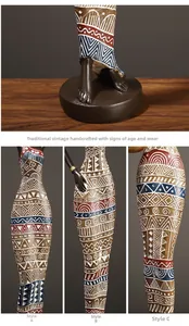 Detail of African tribal women figurines showing textures and vibrant geometric patterns