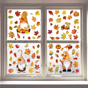 Detail of four autumn window decals featuring gnomes and pumpkins on a wooden frame
